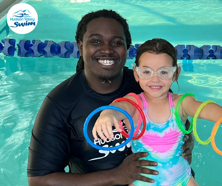 swim instructor with a student in the water