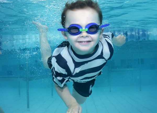 a young boy learning how to swim at hudson valley swim