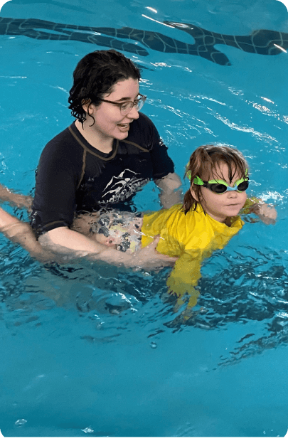 instructor teaching child to swim
